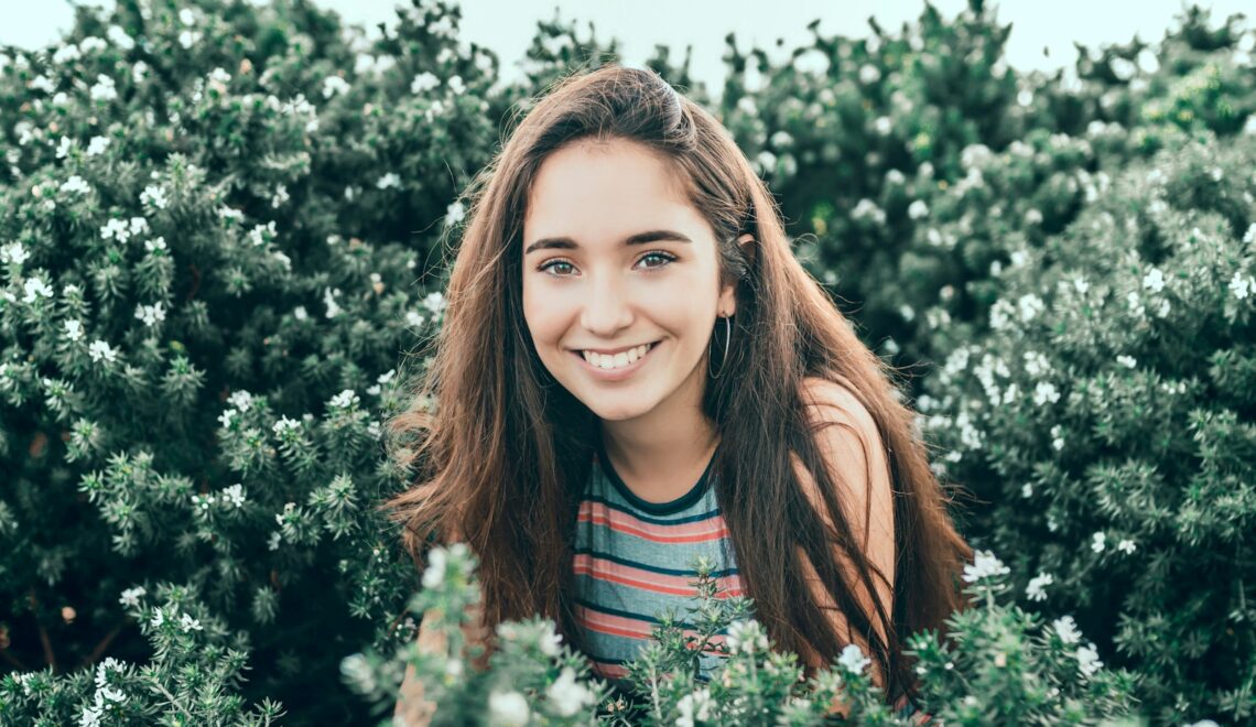 woman standing in bushes