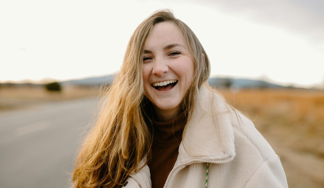 smiling woman in green jacket